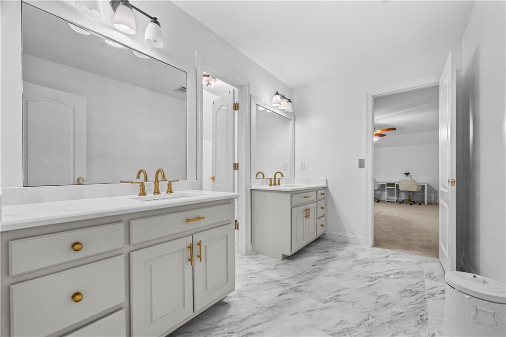 2668 New Hope Road Dacula, GA 30019 - Photo 32 of 65 a spacious bathroom with a double vanity sink a mirror and a