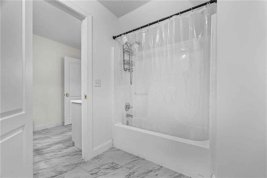 2668 New Hope Road Dacula, GA 30019 - Photo 33 of 65 a bathroom with a bathtub and a shower