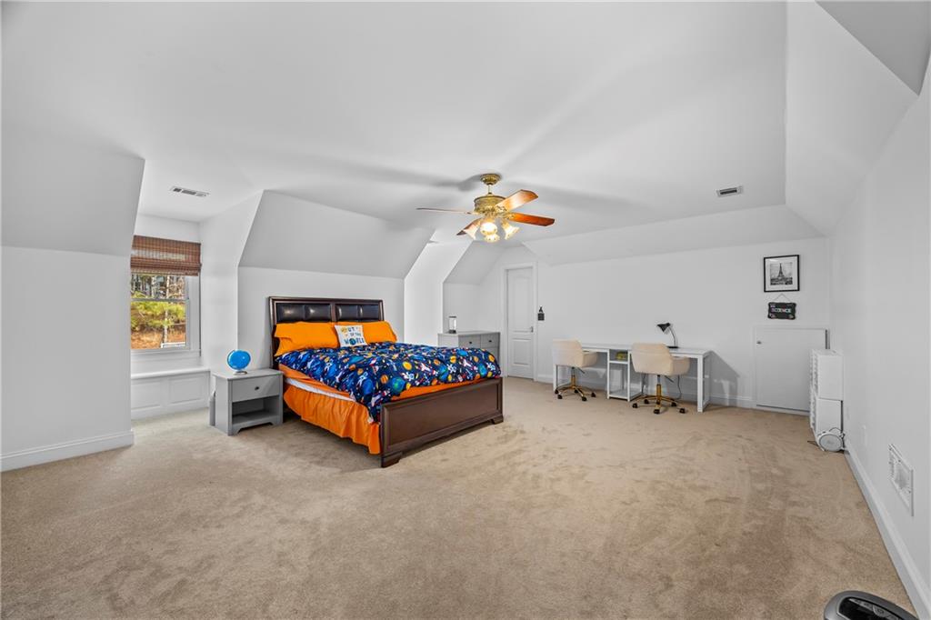 2668 New Hope Road Dacula, GA 30019 - Photo 34 of 65 a bedroom with furniture and a chair