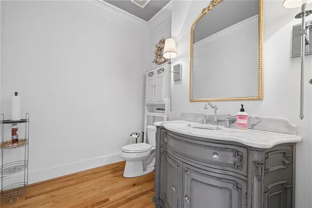 a bathroom with a granite countertop sink mirror and toilet