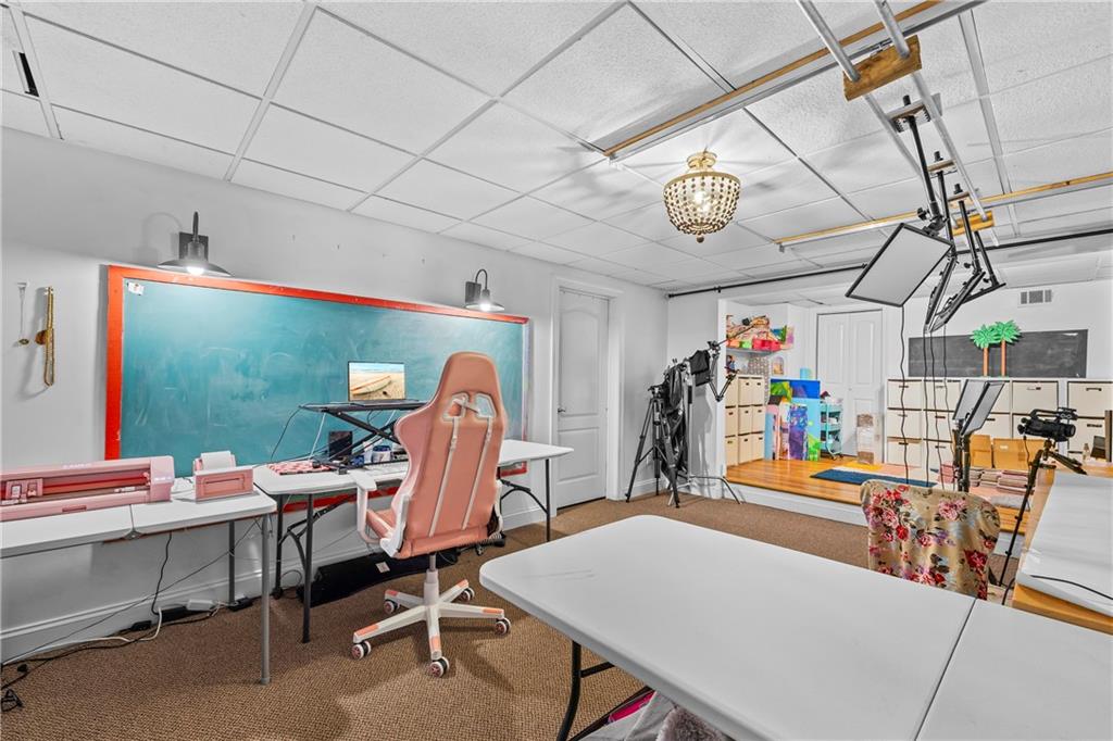 2668 New Hope Road Dacula, GA 30019 - Photo 45 of 65 a dining room with furniture a flat screen tv and a table