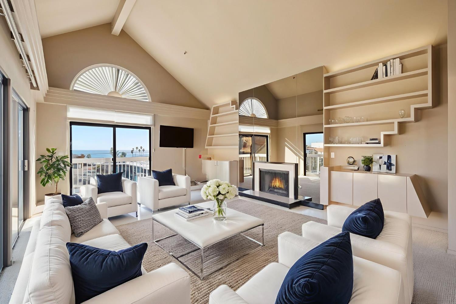 526 Second Street, Unit 301 Santa Cruz, CA 95060 - Photo 2 of 49 Gorgeous sun-filled living room with vaulted ceilings, fireplace, 2 sliding doors leading to large deck and balcony STUNNING ocean views. Photos virtually staged.