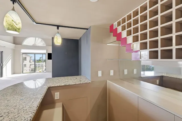 a view of an empty room with cabinet and a window