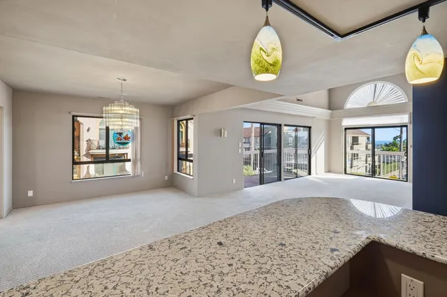 an empty room with windows and painted walls