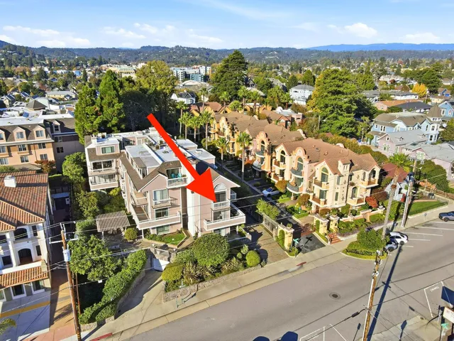 a view of a pathway of a building with wooden fence