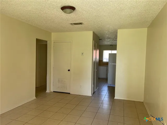 a view of a hallway with wooden shelves