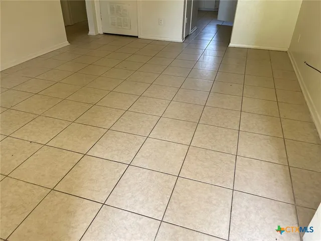 a view of a utility room and empty room