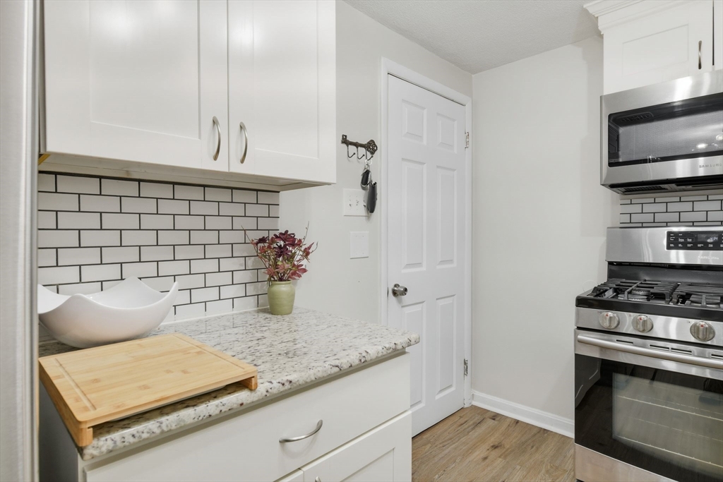 150 Drexel Street Springfield, MA 01104 - Photo 12 of 27 a kitchen with granite countertop a stove and a sink