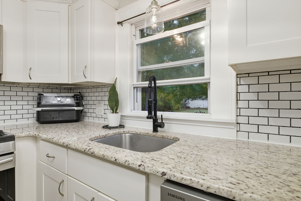 150 Drexel Street Springfield, MA 01104 - Photo 13 of 27 a kitchen with granite countertop a sink and a window