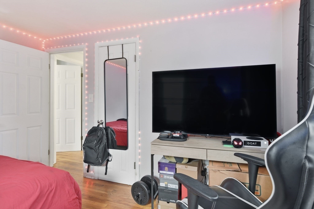 150 Drexel Street Springfield, MA 01104 - Photo 21 of 27 a bedroom with a bed and a flat tv screen