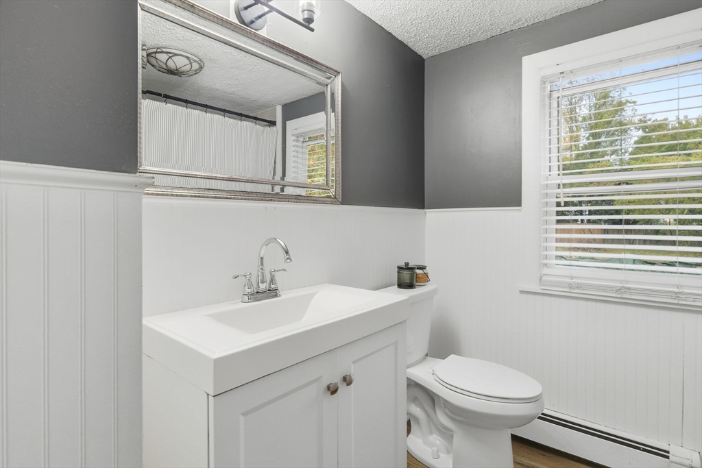 150 Drexel Street Springfield, MA 01104 - Photo 23 of 27 a bathroom with a toilet sink vanity and mirror