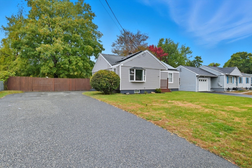 150 Drexel Street Springfield, MA 01104 - Photo 3 of 27 a front view of house with yard and trees in the background