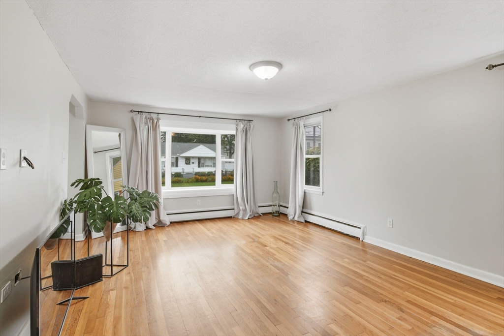 150 Drexel Street Springfield, MA 01104 - Photo 6 of 27 wooden floor in an empty room with a window
