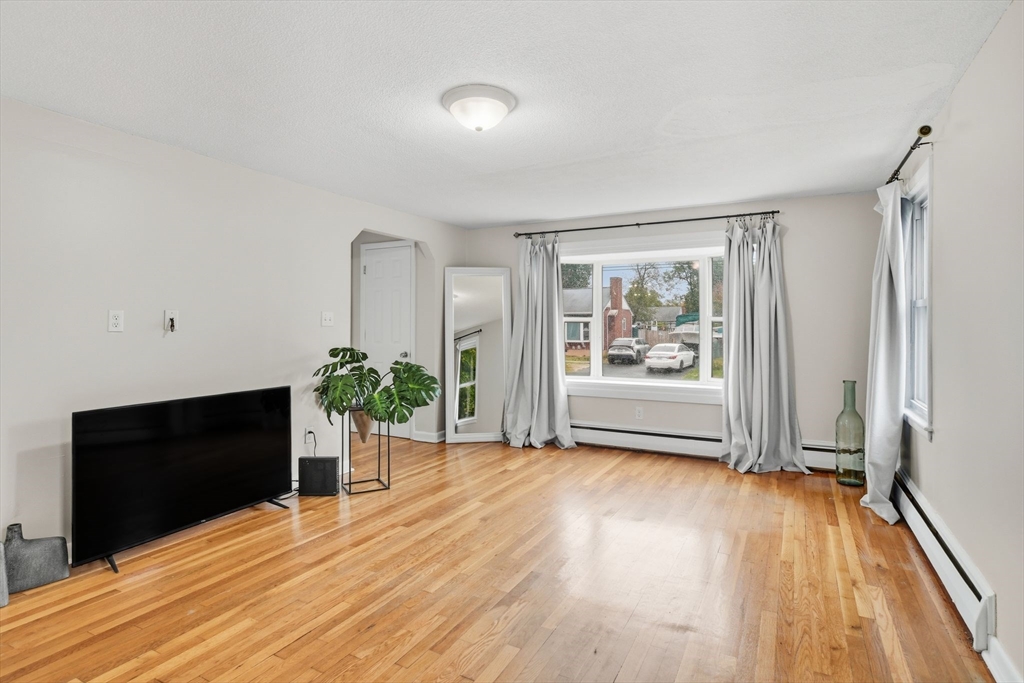 150 Drexel Street Springfield, MA 01104 - Photo 7 of 27 a view of an empty room with wooden floor and a window