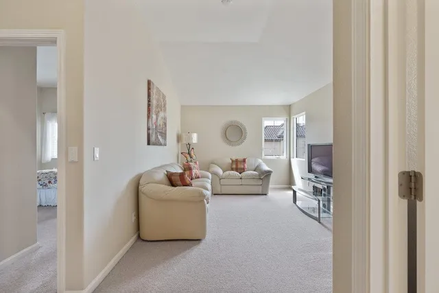 a living room with furniture and a lamp