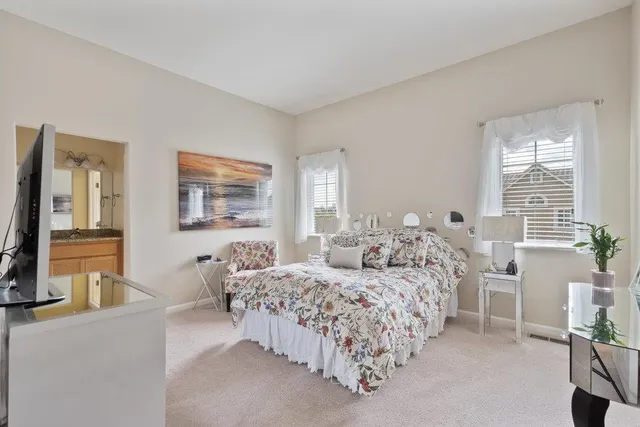 a bedroom with a two bed and a couch