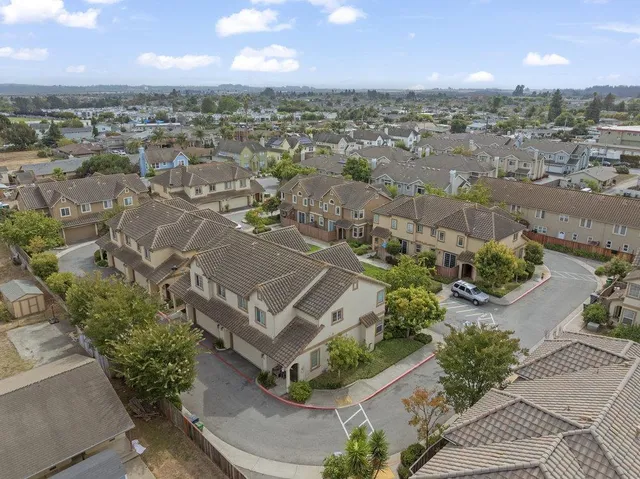 an aerial view of residential houses with outdoor space