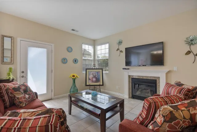 a bedroom with furniture a flat screen tv and a fireplace