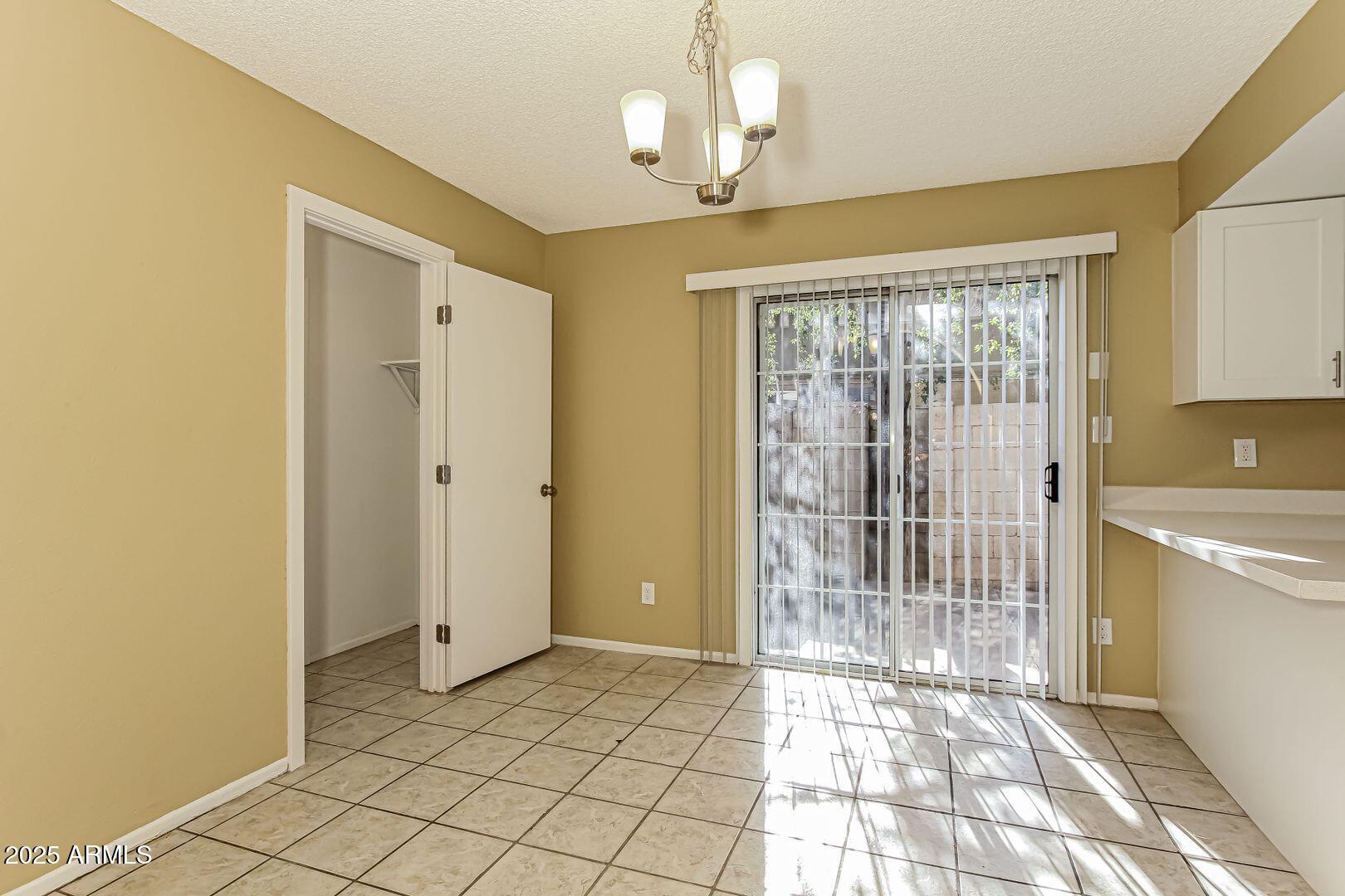 4610 North 75th Drive Phoenix, AZ 85033 - Photo 5 of 14 a view of a room with wooden floor and windows