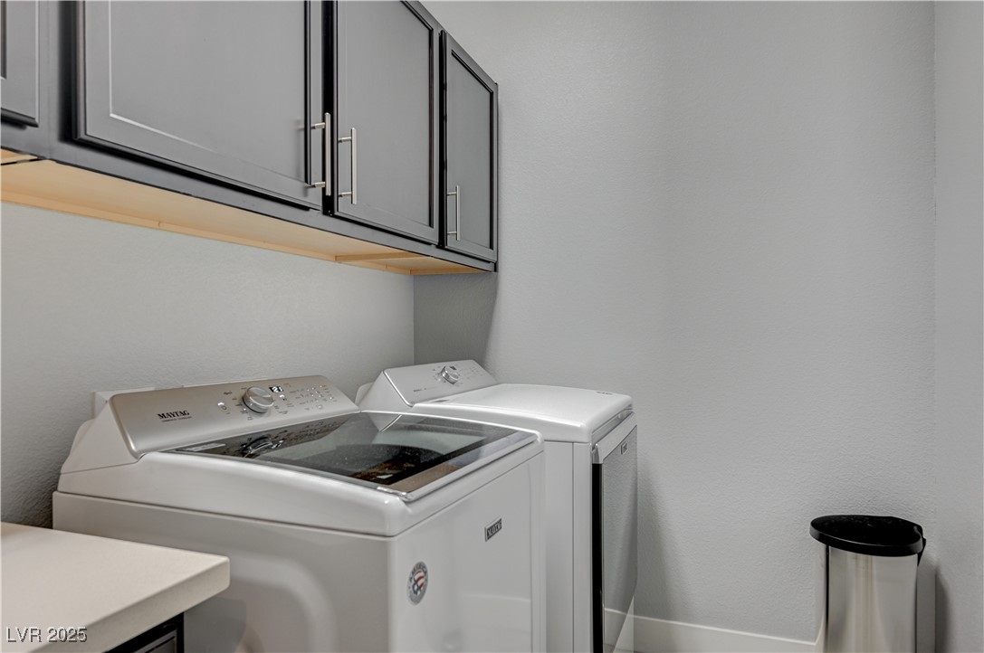 3943 Reyes Avenue Las Vegas, NV 89141 - Photo 26 of 93 Laundry room with cabinet space, washing machine and dryer, and a textured wall