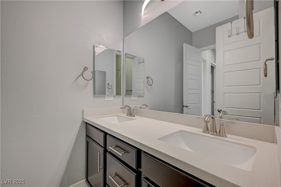3943 Reyes Avenue Las Vegas, NV 89141 - Photo 29 of 93 Full bathroom featuring double vanity and a textured wall