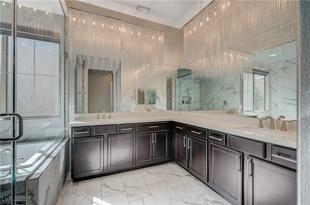3943 Reyes Avenue Las Vegas, NV 89141 - Photo 30 of 93 Full bathroom with light marble finish flooring, double vanity, a garden tub, and a marble finish shower