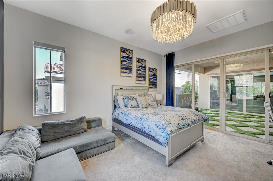 3943 Reyes Avenue Las Vegas, NV 89141 - Photo 41 of 93 Carpeted bedroom with access to exterior, a chandelier, and multiple windows