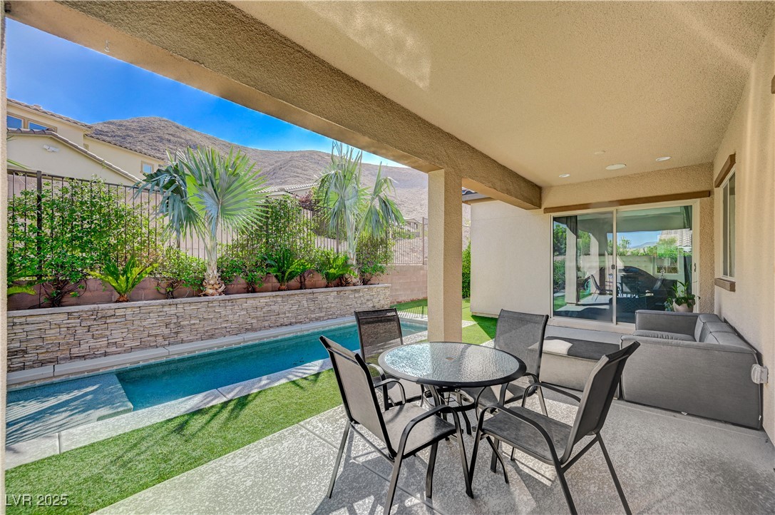 3943 Reyes Avenue Las Vegas, NV 89141 - Photo 48 of 93 Fenced backyard featuring a patio area, a mountain view, and outdoor dining area