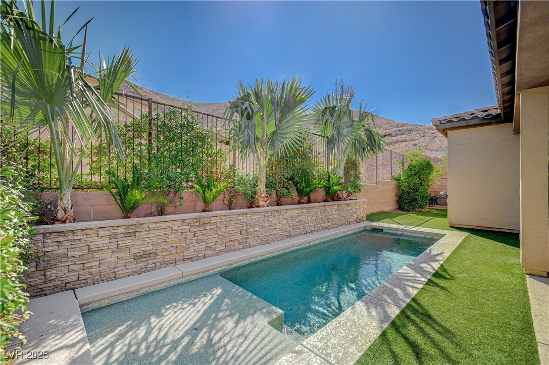 3943 Reyes Avenue Las Vegas, NV 89141 - Photo 53 of 93 View of swimming pool with a patio, a fenced backyard, and a mountain view