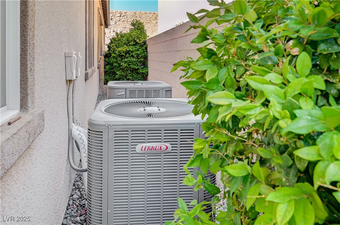 3943 Reyes Avenue Las Vegas, NV 89141 - Photo 55 of 93 Exterior view of a central AC unit and stucco siding