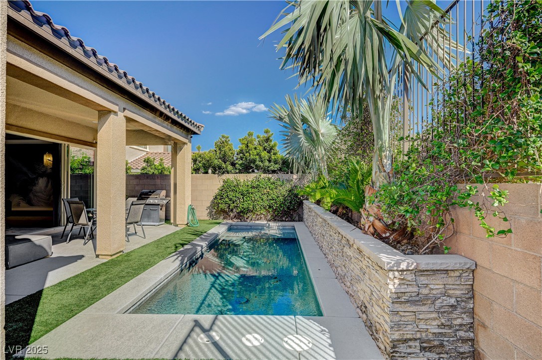 3943 Reyes Avenue Las Vegas, NV 89141 - Photo 56 of 93 View of pool with a patio, a fenced backyard, and a grill
