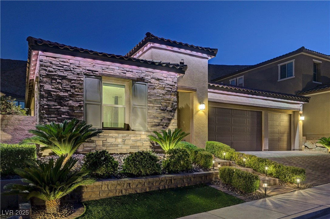 3943 Reyes Avenue Las Vegas, NV 89141 - Photo 85 of 93 Mediterranean / spanish house with stone siding, a garage, decorative driveway, and stucco siding
