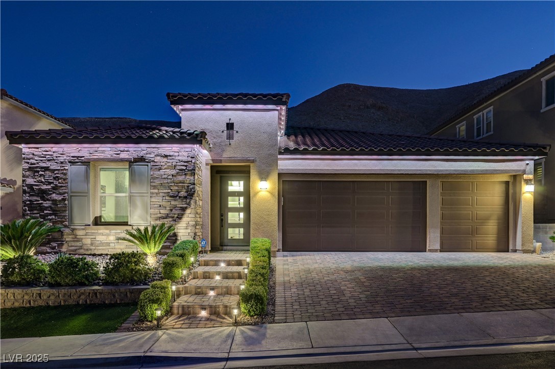 3943 Reyes Avenue Las Vegas, NV 89141 - Photo 86 of 93 Mediterranean / spanish house with stone siding, stucco siding, driveway, a garage, and a tile roof