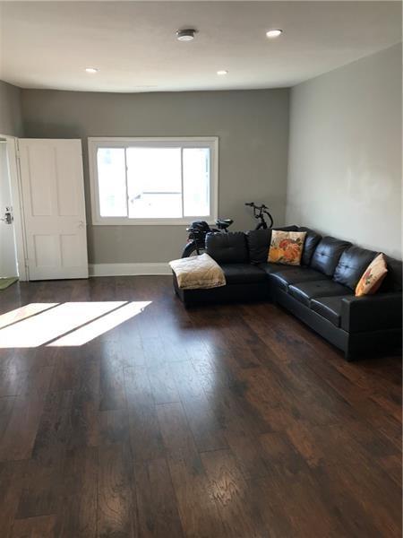 1124 Brabec Street Pittsburgh, PA 15212 - Photo 2 of 11 a living room with couches and a large window