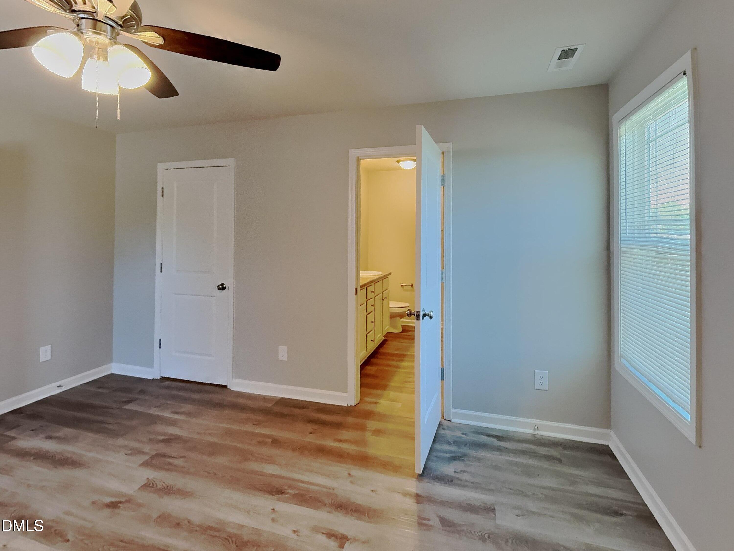 123 Willow Ridge Circle Willow Spring, NC 27592 - Photo 6 of 15 wooden floor in an empty room with a window