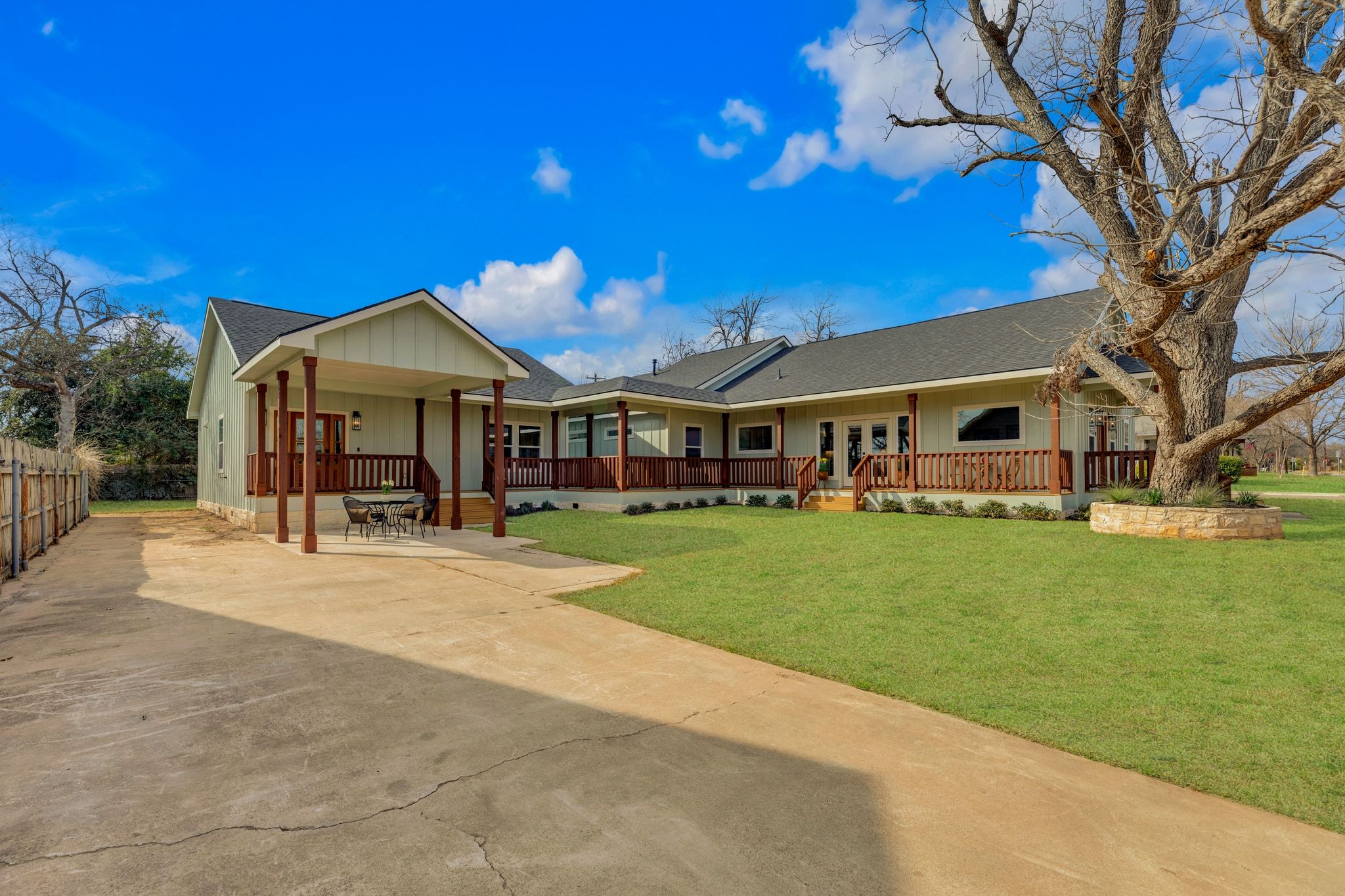 2102 South Church Street Georgetown, TX 78626 - Photo 4 of 40 View of one of two driveways, front facade featuring board and batten siding, a shingled roof, a front lawn, french doors, and a carport.
