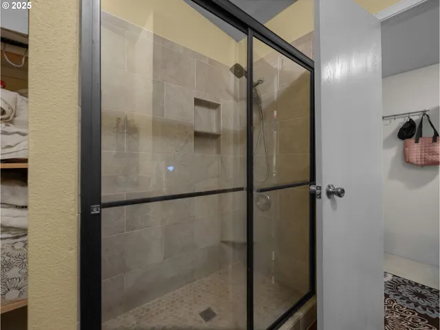 a bathroom with a glass shower door