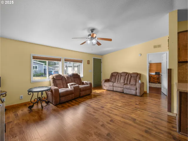 a living room with fireplace furniture and a window