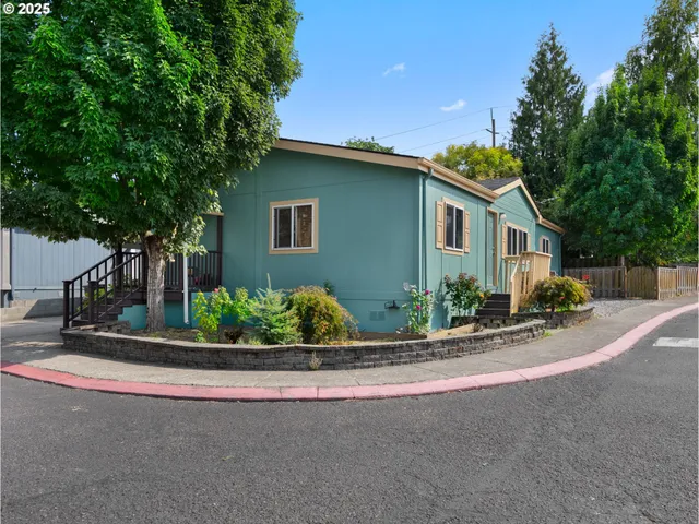 a front view of a house with garage and outdoor seating