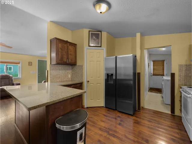a kitchen with a refrigerator a sink and a stove top oven