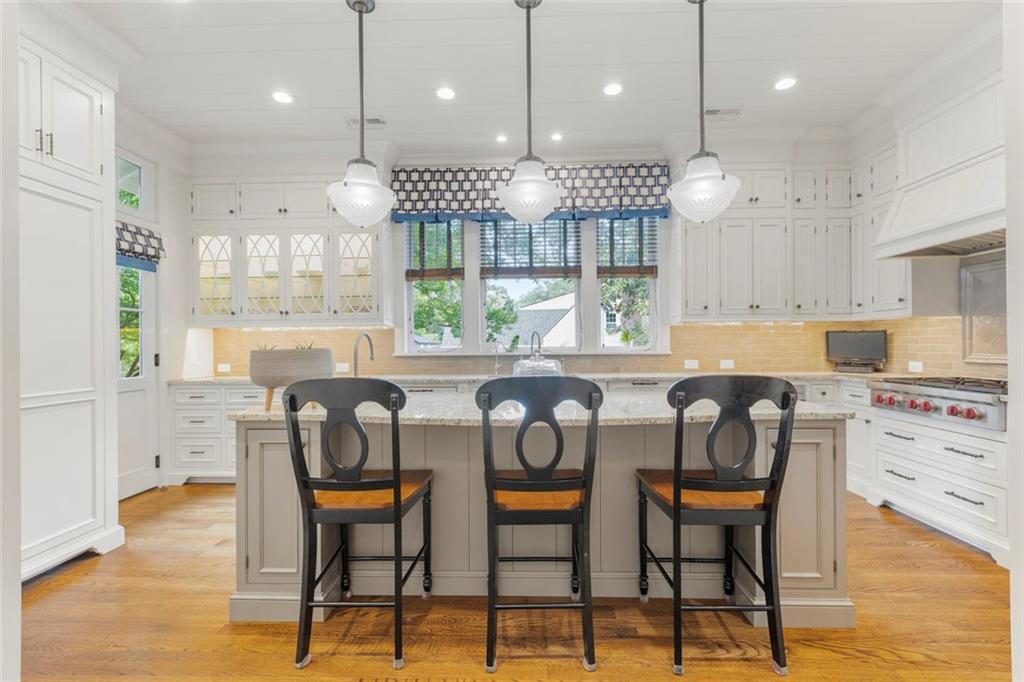 1982 West Rugby Avenue Atlanta, GA 30337 - Photo 13 of 42 a kitchen with stainless steel appliances granite countertop a stove a sink a oven a refrigerator with a dining table and chairs