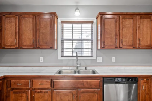 a kitchen with stainless steel appliances granite countertop a sink and a cabinets