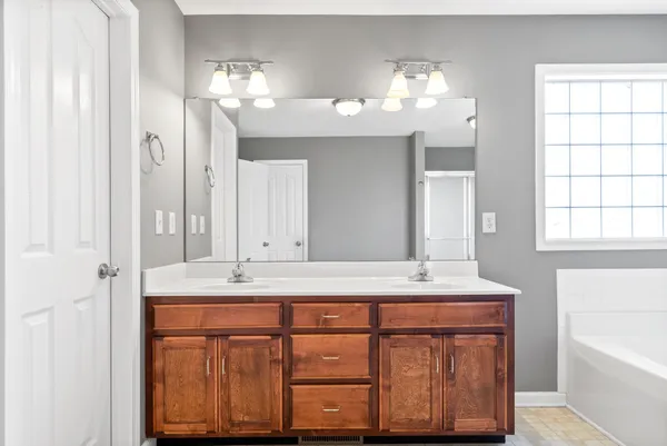 a bathroom with a sink vanity and a mirror
