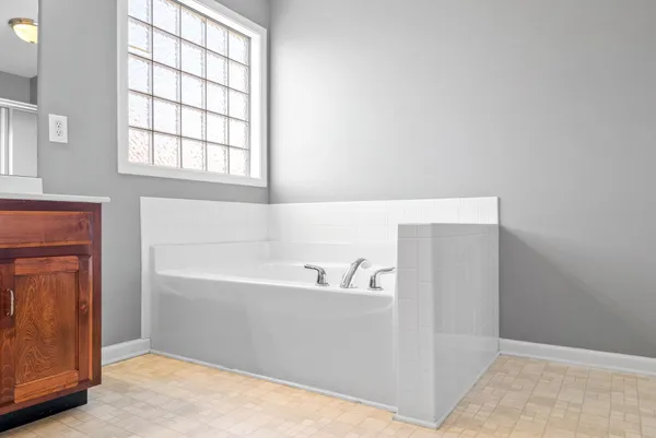 a bathroom with a bathtub and a window