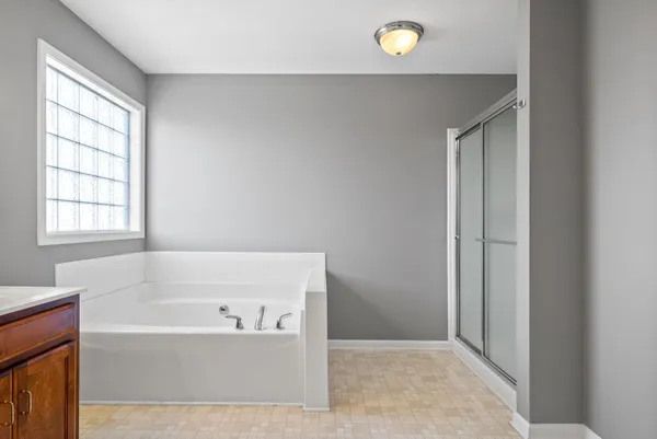 a bathroom with a bathtub and shower