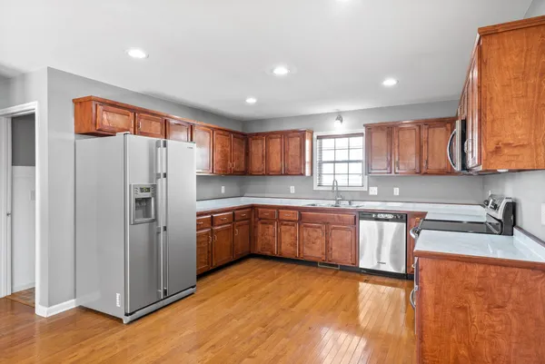 a kitchen with stainless steel appliances granite countertop a refrigerator and a sink