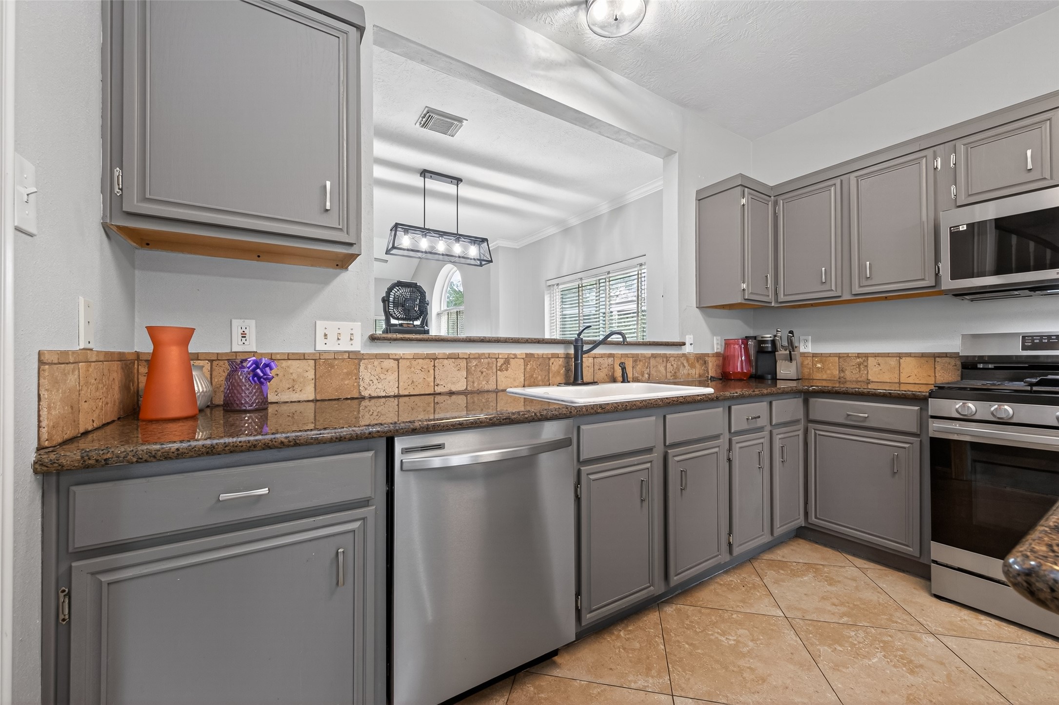 16902 Canyon Ridge Drive Spring, TX 77379 - Photo 13 of 43 a kitchen with stainless steel appliances granite countertop a sink and cabinets