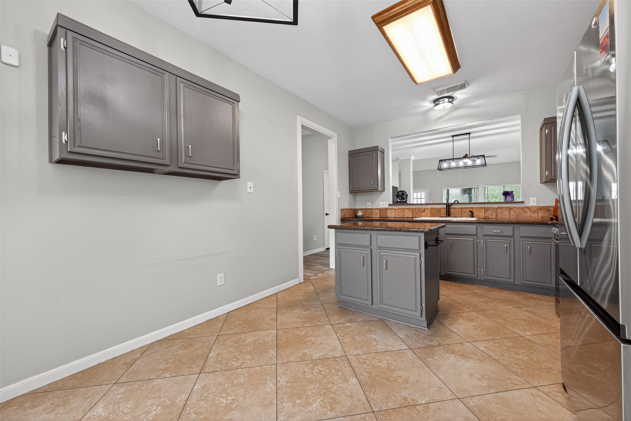 16902 Canyon Ridge Drive Spring, TX 77379 - Photo 18 of 43 a kitchen with stainless steel appliances a sink and cabinets