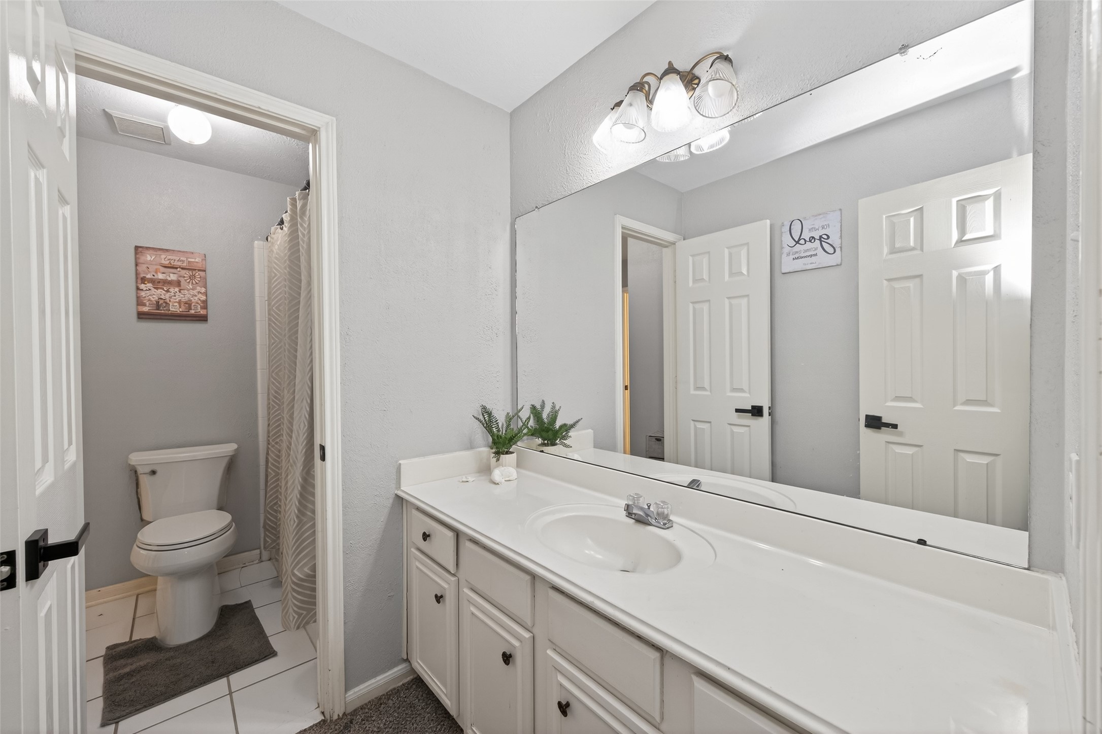 16902 Canyon Ridge Drive Spring, TX 77379 - Photo 33 of 43 a bathroom with a toilet a sink and mirror