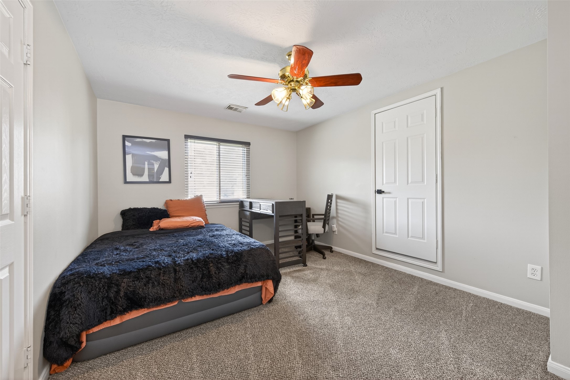 16902 Canyon Ridge Drive Spring, TX 77379 - Photo 37 of 43 a bedroom with a bed a window and a chandelier